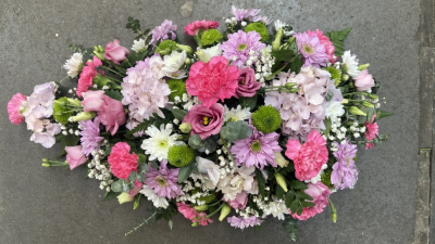 Pink single ended spray - A classic pink funeral spray in a mix of favourite flowers (flower content may be substituted)