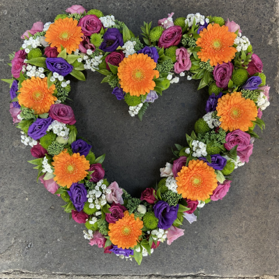 Vibrant loose open heart - A vibrant loose open heart in a fabulous mix of flowers - to commemorate the life of your loved one.