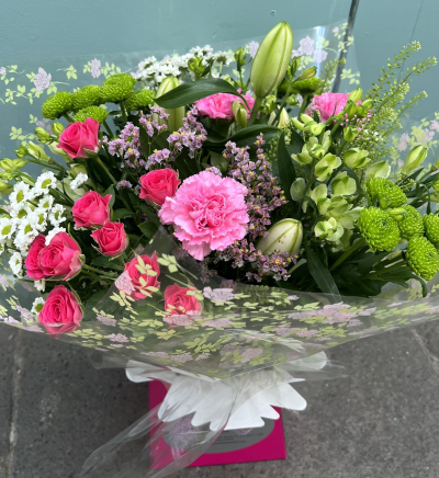 Blushing Meadow - A stunning collection of pink and green seasonal flowers in toning packaging. This bouquet is designed to impress and uplift any space.