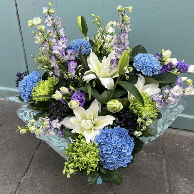 Oceanic Bliss - Revel in the elegance of this luxurious bouquet, featuring a captivating mix of white and blue blooms. Presented in beautiful packaging, it’s perfect for making a sophisticated statement.