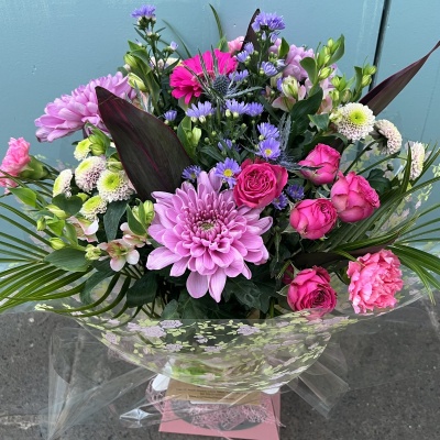 Hidden Treasure - An outstanding hand tied bouquet with a cascade of colour and a treasure chest overflowing with the beautiful flowers.