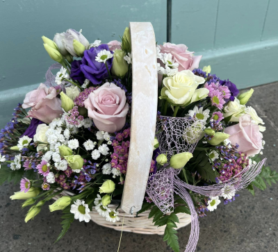 Bon Bon - Shower them with love with this cutesy collection of seasonal flowers in pretty pastels. Beautifully arranged and stylishly presented in a traditional basket.