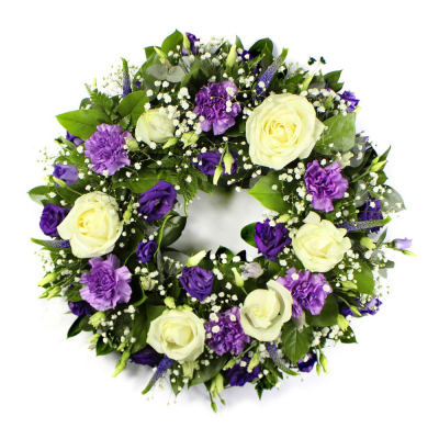 Wreath SYM-316 - A beautiful classic wreath arranged using purple and white flowers and finished with fine foliage.